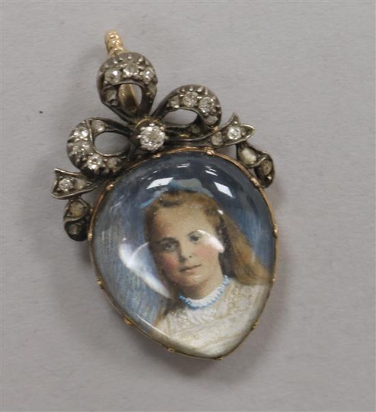 An early 20th century yellow metal and diamond set pear shaped miniature portrait pendant, 35mm.